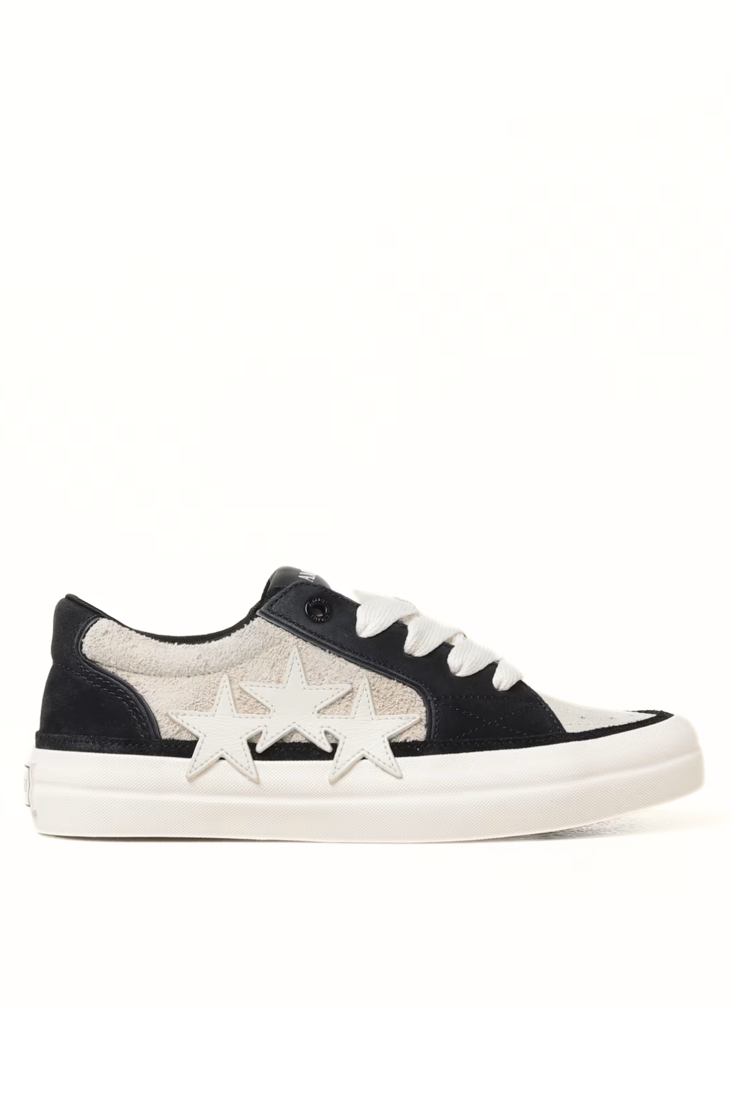 A pair of Amiri men's low-top sneakers in black suede with a white sole, featuring a lace-up closure and a round, floral-decorated heel.